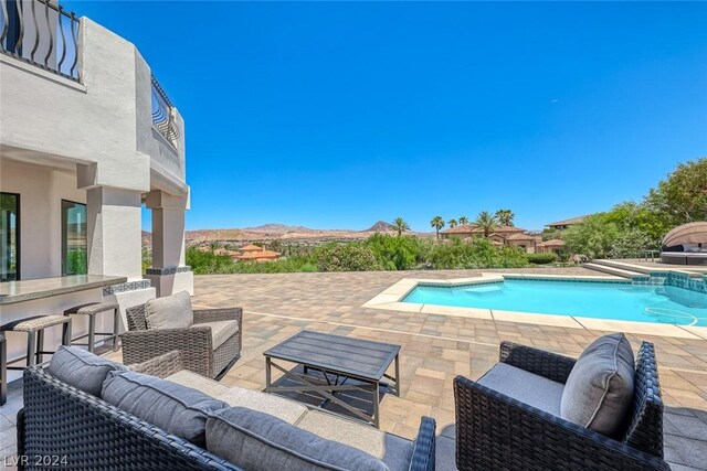 view of pool featuring a patio area and an outdoor living space