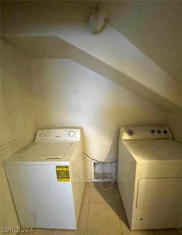 washroom with light tile patterned floors and washer / dryer