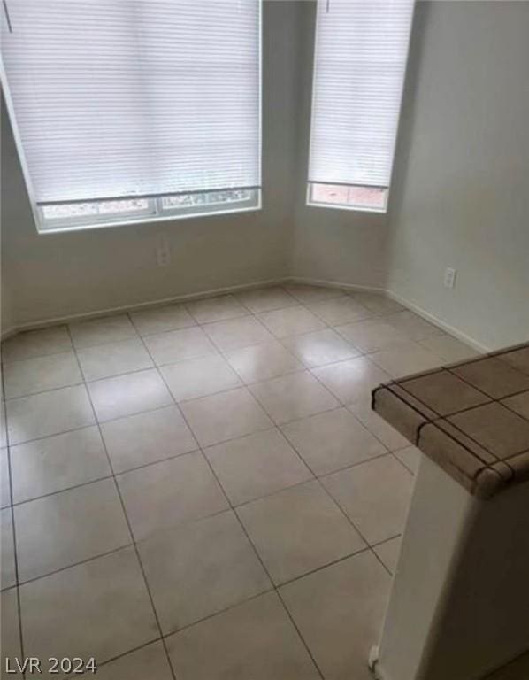 spare room featuring light tile patterned flooring