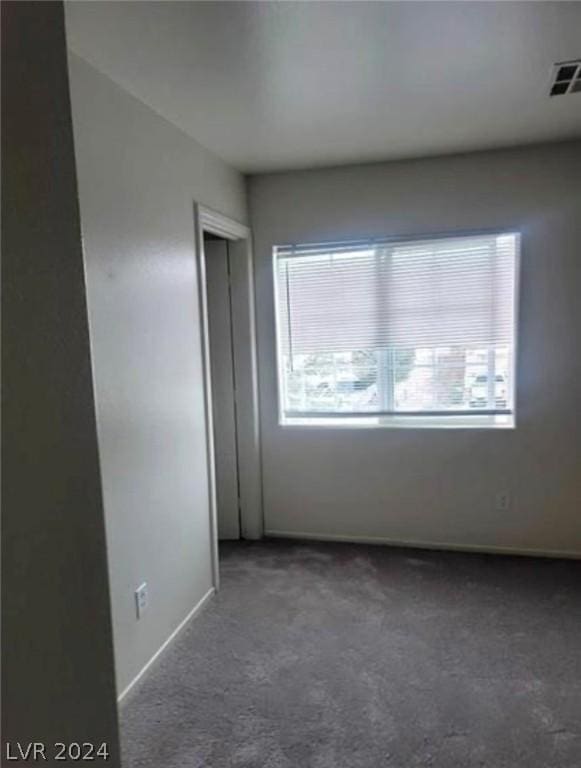 carpeted empty room featuring plenty of natural light