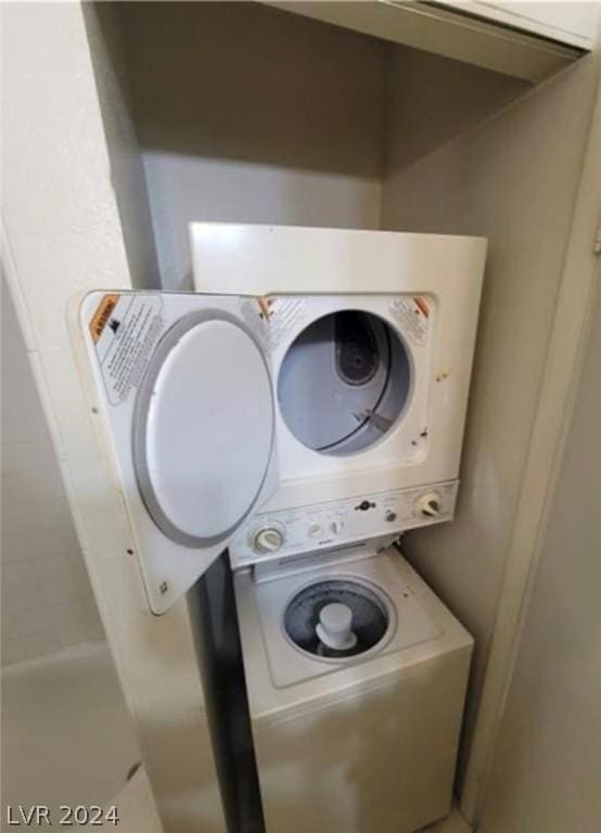 laundry area with stacked washer and dryer