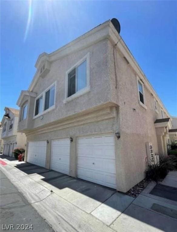 view of side of home featuring a garage