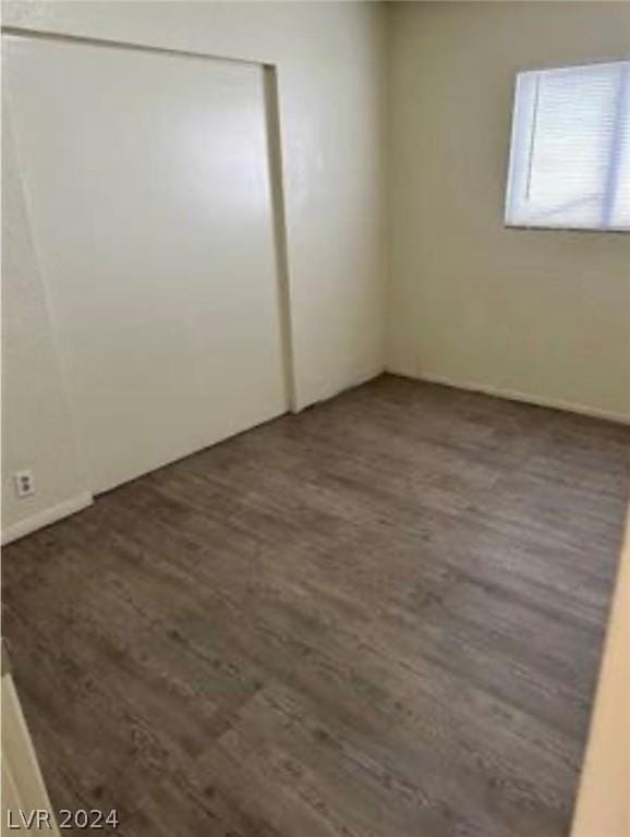 empty room featuring dark hardwood / wood-style flooring