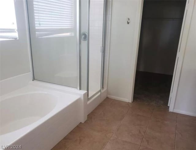 bathroom with tile patterned floors, plenty of natural light, and separate shower and tub