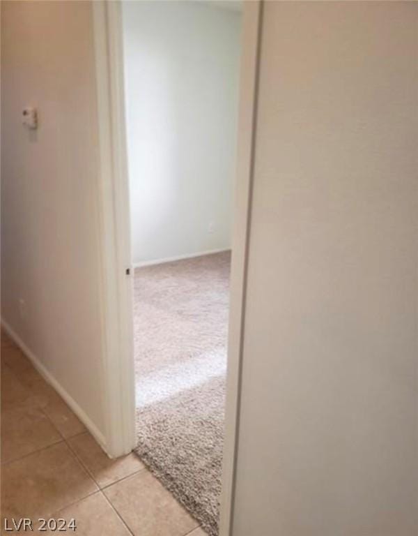 hall featuring light tile patterned flooring