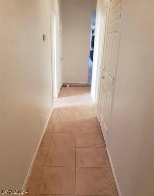 corridor with light tile patterned floors