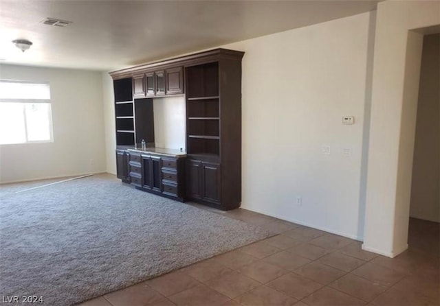 unfurnished living room featuring carpet floors