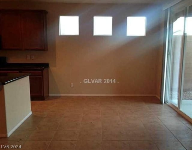 unfurnished dining area with light tile patterned floors