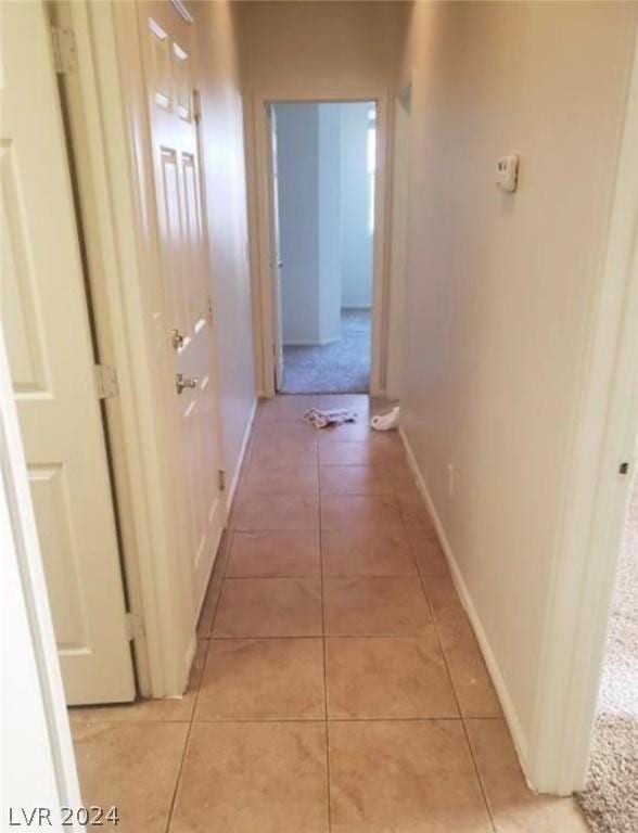 hallway featuring light tile patterned floors