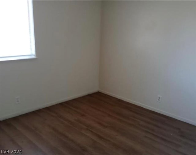 empty room featuring dark wood-type flooring