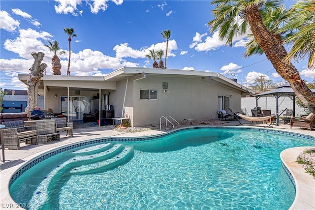 view of pool featuring a gazebo and a patio area