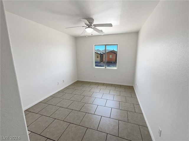 unfurnished room featuring ceiling fan and light tile patterned floors