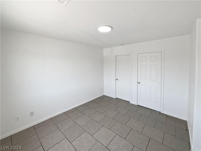 unfurnished bedroom featuring tile patterned flooring