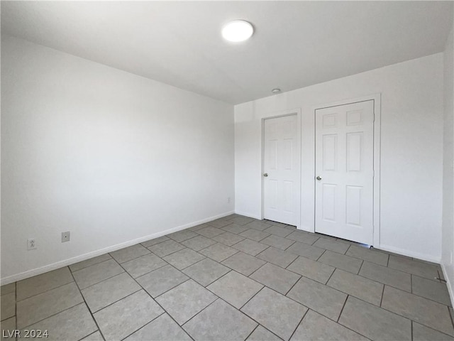 unfurnished bedroom featuring light tile patterned flooring