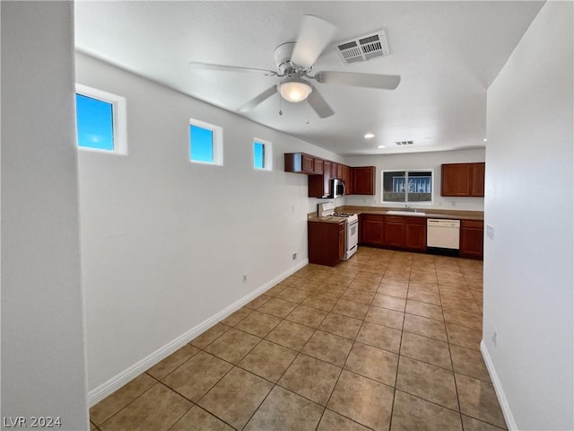 kitchen featuring sink, ceiling fan, white appliances, and light tile patterned flooring