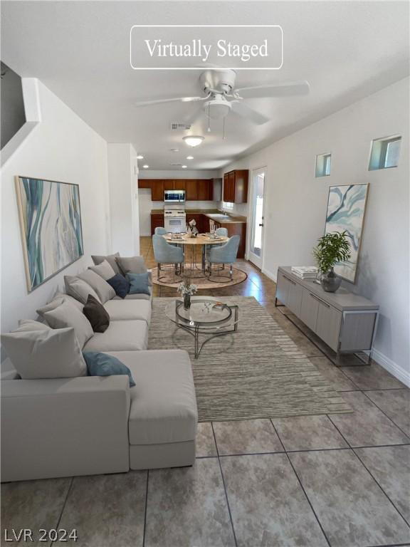 living room with tile floors and ceiling fan