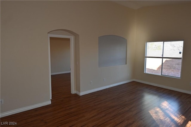 spare room featuring dark wood-type flooring