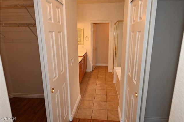 bathroom with vanity, tile patterned floors, and a shower