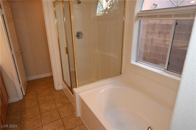 bathroom featuring a wealth of natural light, tile patterned floors, and separate shower and tub