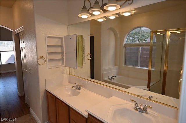 bathroom with vanity and shower with separate bathtub