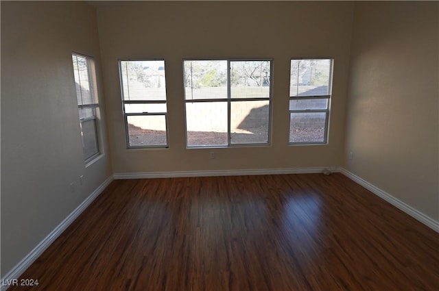 empty room with dark hardwood / wood-style flooring