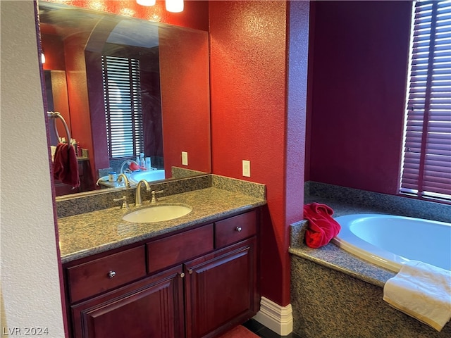 bathroom with a bathing tub and vanity