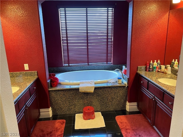 bathroom featuring tile floors, tiled bath, and vanity