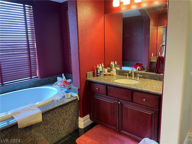 bathroom with a washtub, vanity, and tile floors