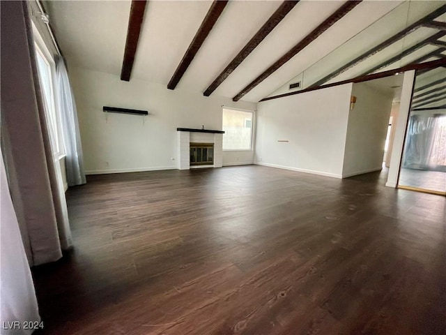 unfurnished living room with a fireplace, lofted ceiling with beams, and dark hardwood / wood-style floors