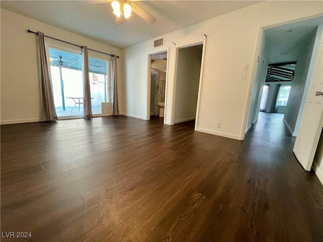 unfurnished room featuring ceiling fan and dark wood-type flooring