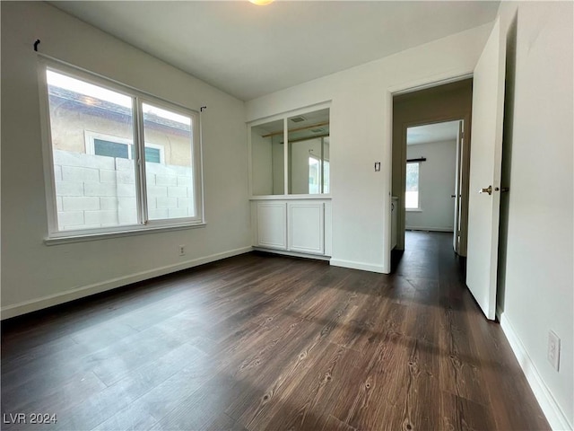 unfurnished bedroom with dark hardwood / wood-style flooring