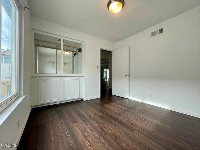 spare room with dark hardwood / wood-style flooring