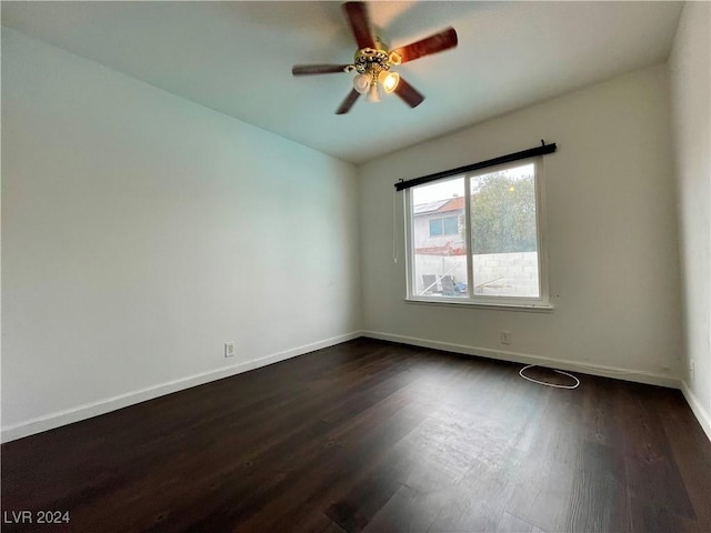 unfurnished room featuring ceiling fan and dark wood-type flooring