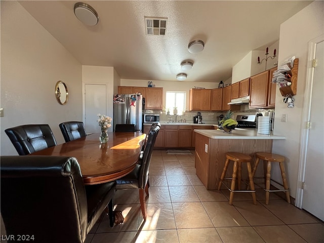 tiled dining room featuring sink