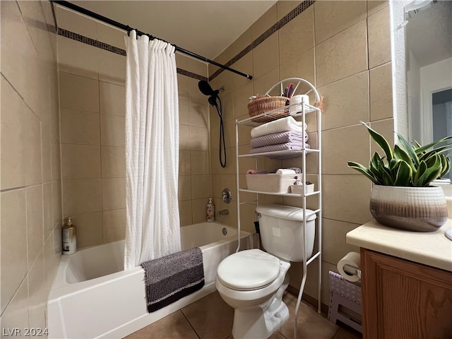 full bathroom featuring vanity, tile patterned floors, tile walls, shower / bath combo, and toilet