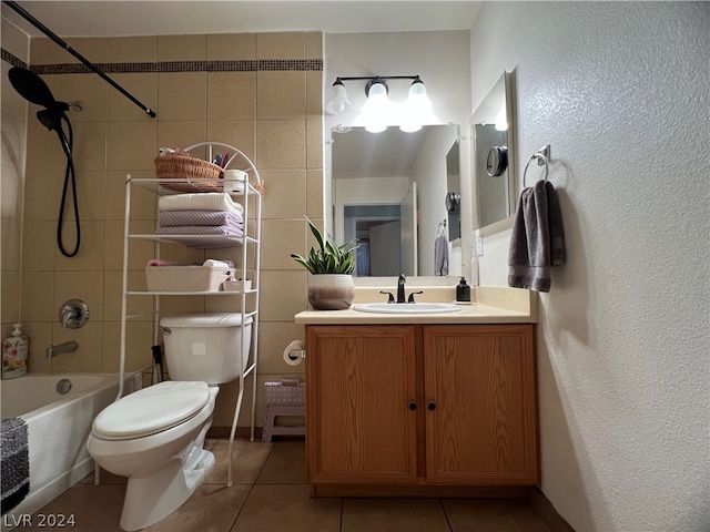 full bathroom with toilet, tile patterned floors, tiled shower / bath combo, and vanity