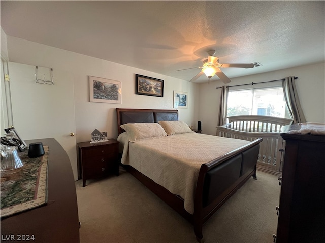 bedroom with carpet flooring, a textured ceiling, and ceiling fan