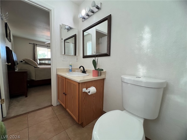 bathroom with vanity, toilet, and tile patterned floors