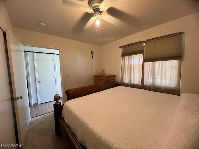 bedroom with dark colored carpet and ceiling fan