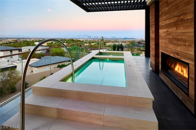 view of pool at dusk