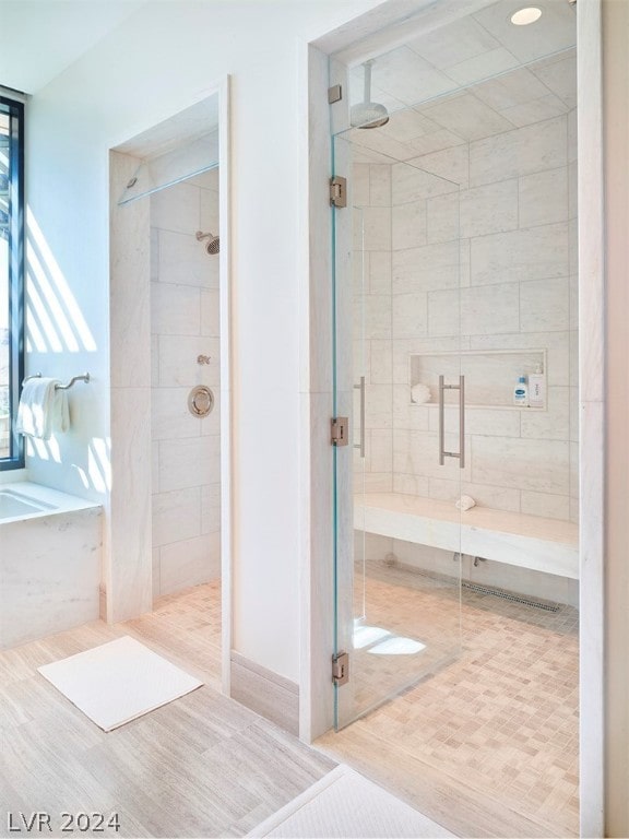 bathroom featuring tile patterned floors and separate shower and tub