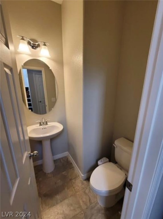 bathroom with tile flooring and toilet