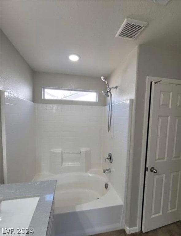 bathroom featuring tub / shower combination and vanity