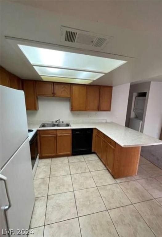 4300 N Lamont St Unit 232, Las Vegas, NV 89115 - kitchen with dishwasher, white fridge, kitchen peninsula, sink, and light tile patterned flooring