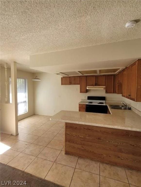 4300 N Lamont St Unit 232, Las Vegas, NV 89115 - kitchen with kitchen peninsula, electric range, sink, and light tile patterned flooring