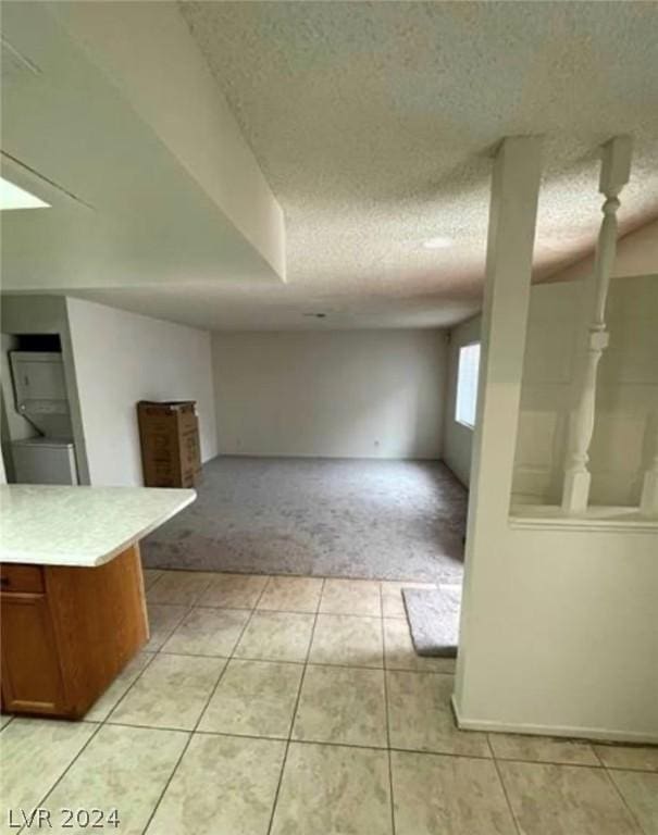 4300 N Lamont St Unit 232, Las Vegas, NV 89115 - interior space featuring a textured ceiling, light tile patterned floors, and kitchen peninsula