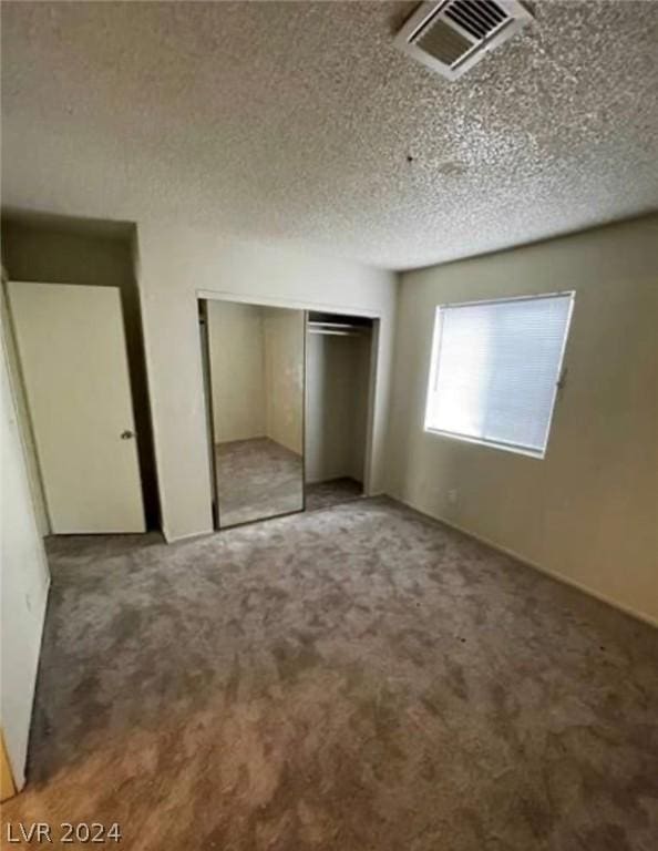 4300 N Lamont St Unit 232, Las Vegas, NV 89115 - unfurnished bedroom featuring carpet floors, a textured ceiling, and a closet