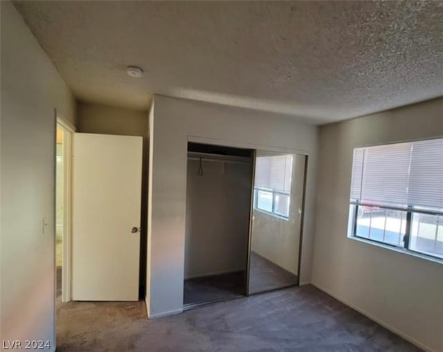 4300 N Lamont St Unit 232, Las Vegas, NV 89115 - unfurnished bedroom with carpet floors, a closet, and a textured ceiling