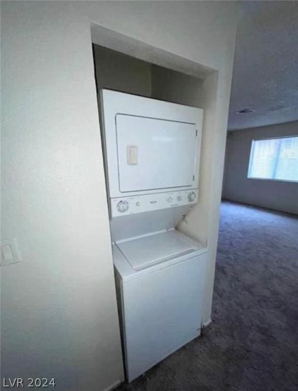 4300 N Lamont St Unit 232, Las Vegas, NV 89115 - washroom featuring stacked washer and clothes dryer and dark carpet