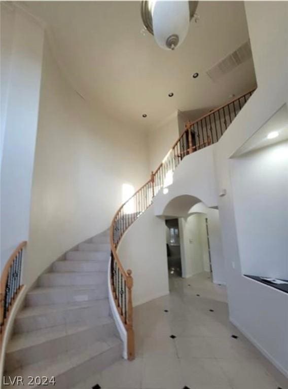 stairs featuring a high ceiling